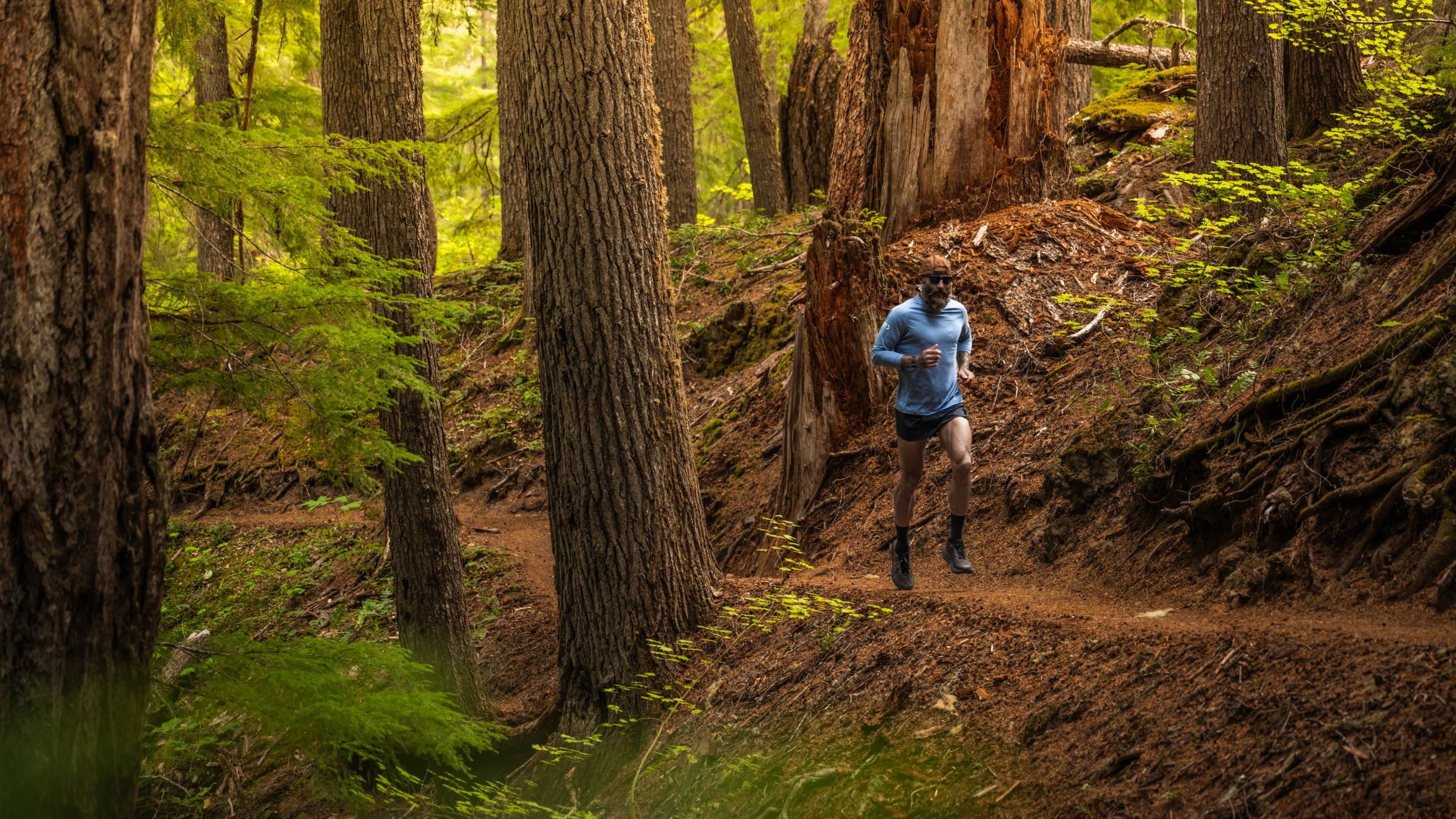 iFIT trainer Tommy Rivs running on a forest trail near Sahalie Falls, Oregon, during Joy of Running Part 3